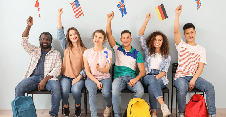 Young students of language school near color wall